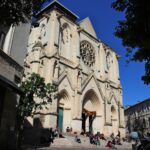 people walking near white concrete church during daytime